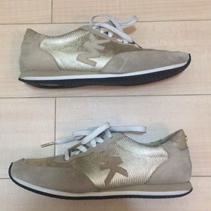 Michael Kors gold sneakers.